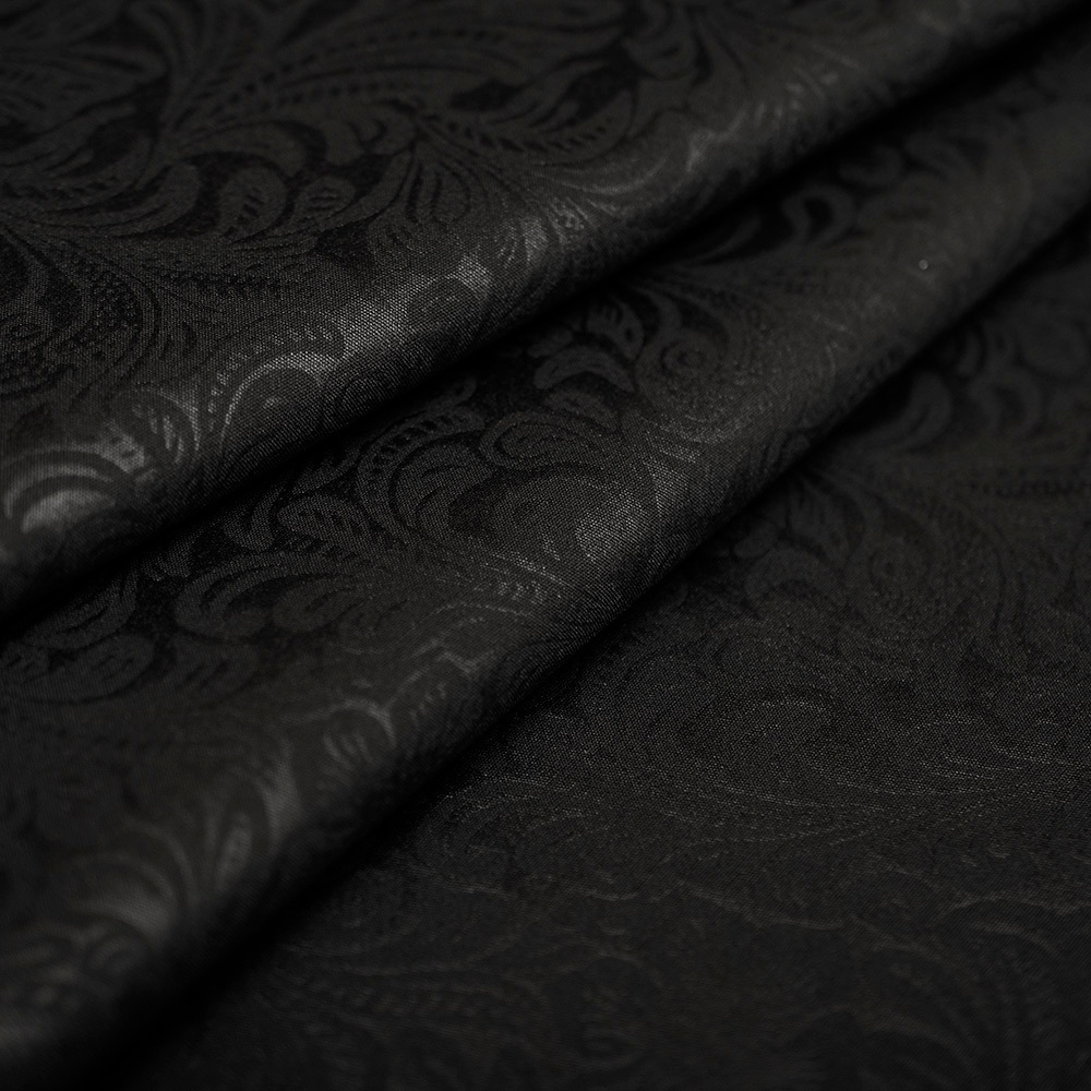 Tkanina żakardowa o jednolitym kolorze to elegancki materiał wyróżniający się charakterystycznym, strukturalnym wzorem powstającym bezpośrednio w procesie tkania.