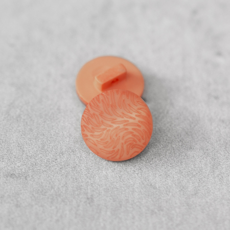 Plastikowy guzik na stopce, o średnicy 1,5 cm.
